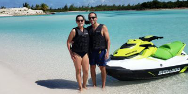Couple standing by Jet Ski